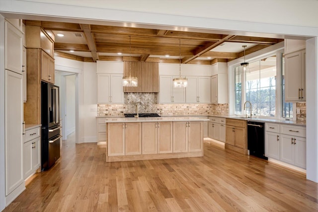 kitchen with light hardwood / wood-style flooring, hanging light fixtures, a kitchen island with sink, and coffered ceiling