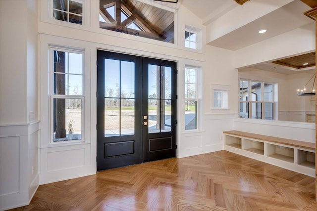 entryway featuring french doors, light parquet flooring, an inviting chandelier, and wooden ceiling