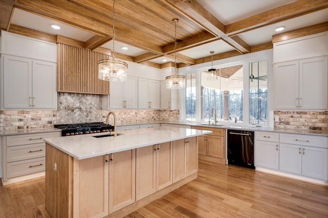kitchen with a center island with sink, decorative light fixtures, white cabinets, and dishwasher