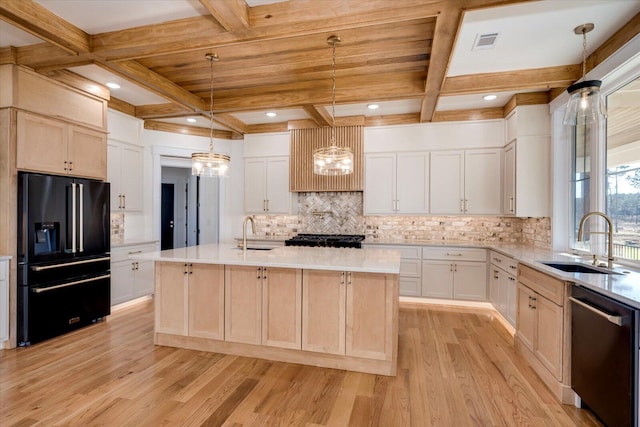 kitchen featuring decorative light fixtures, high end black refrigerator, dishwasher, white cabinetry, and an island with sink