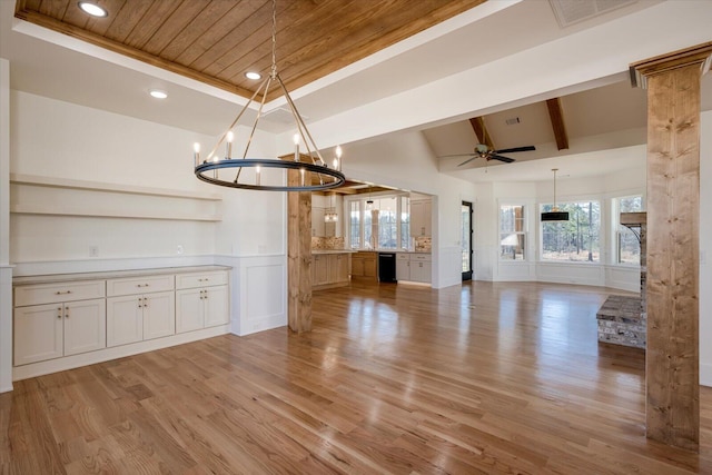 unfurnished dining area featuring lofted ceiling with beams, wooden ceiling, light hardwood / wood-style floors, and ceiling fan with notable chandelier