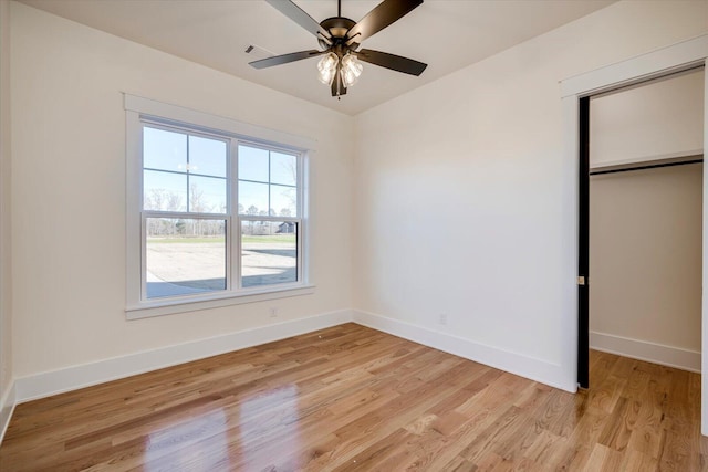 unfurnished bedroom with light wood-type flooring, a closet, and ceiling fan