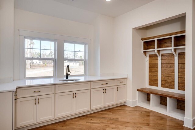 mudroom featuring sink and light hardwood / wood-style flooring