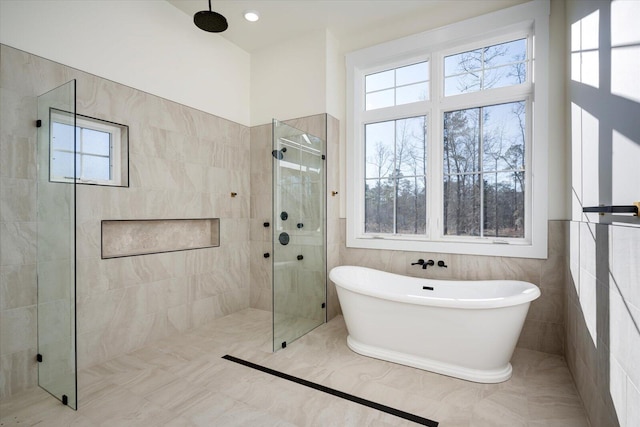 bathroom with a healthy amount of sunlight and independent shower and bath