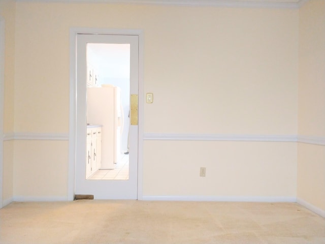 carpeted empty room with baseboards