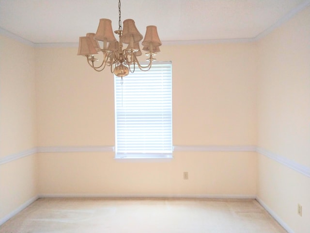 empty room with a chandelier and baseboards