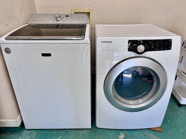 clothes washing area with washer and clothes dryer