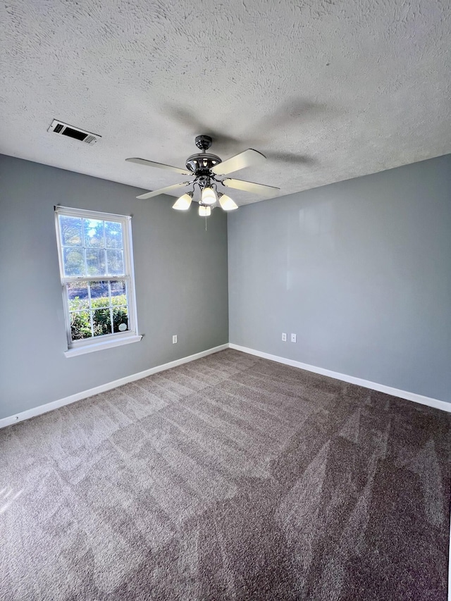 unfurnished room with a ceiling fan, carpet flooring, baseboards, and a textured ceiling