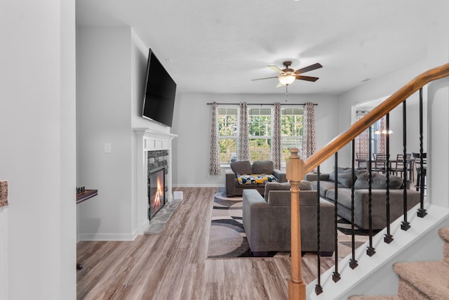 120 Dublin Loop, Grovetown, GA 30813 - living area featuring stairs, light wood finished floors, a stone fireplace, and a ceiling fan