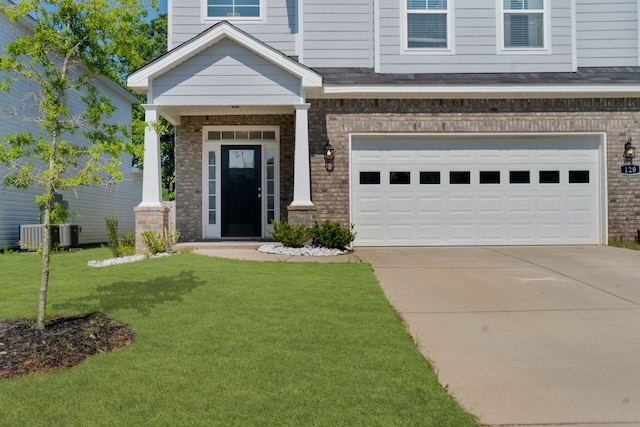 120 Dublin Loop, Grovetown, GA 30813 - doorway to property with brick siding, a garage, a yard, and concrete driveway