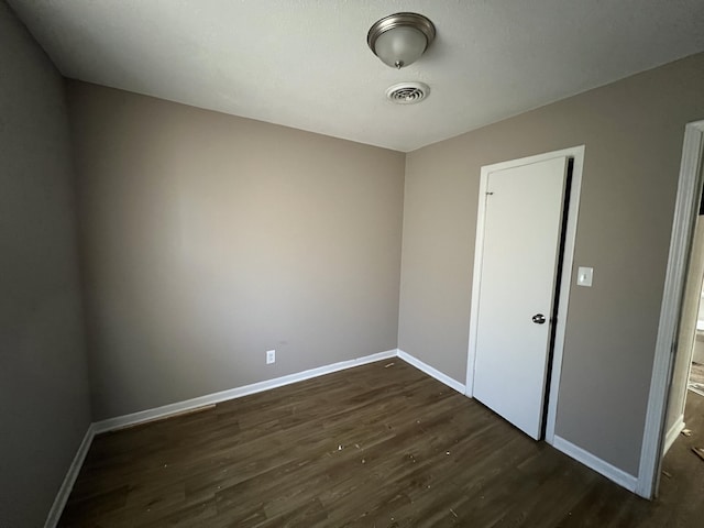 empty room featuring dark wood-type flooring