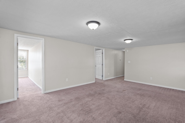 empty room featuring carpet and a textured ceiling