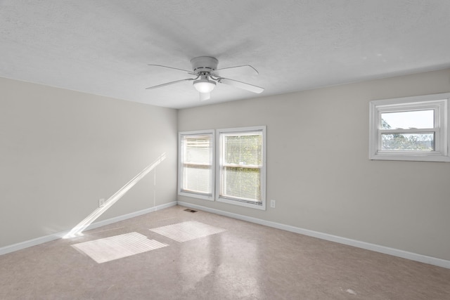 empty room with a textured ceiling and ceiling fan