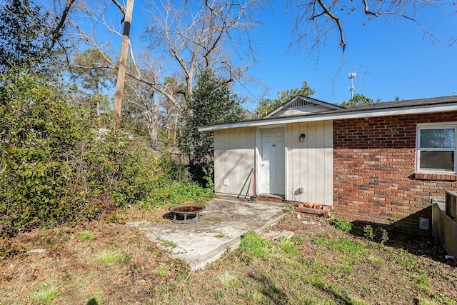 view of outbuilding featuring a fire pit