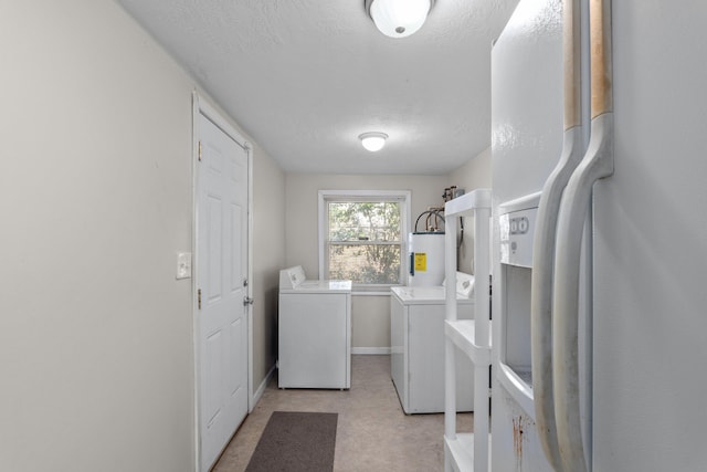 laundry area featuring washer and dryer, a textured ceiling, and water heater