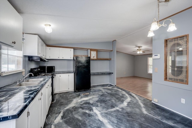 kitchen featuring black fridge, sink, white cabinets, and ceiling fan