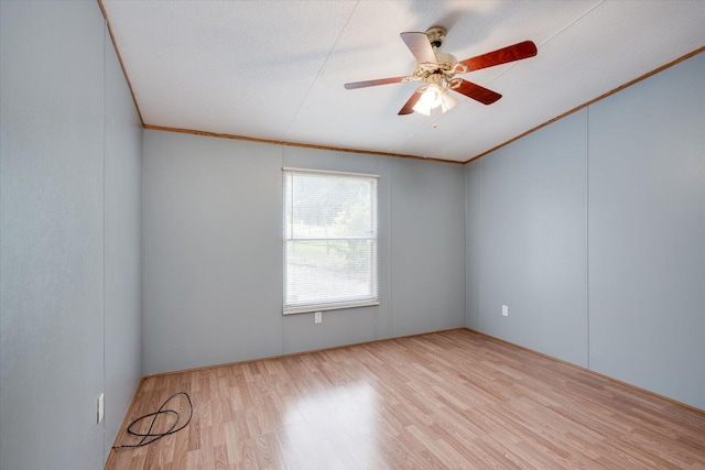 spare room featuring ceiling fan, light hardwood / wood-style floors, and ornamental molding