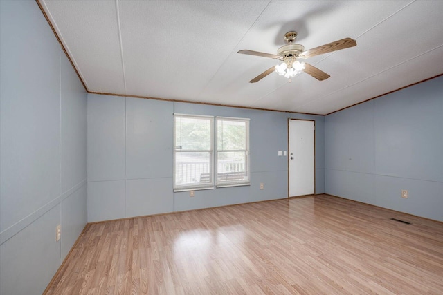 spare room with ceiling fan, crown molding, a textured ceiling, and light hardwood / wood-style flooring