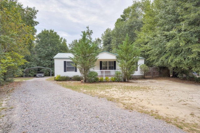 single story home featuring covered porch and a carport