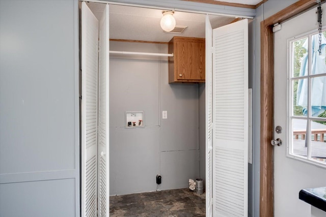 laundry room featuring hookup for a washing machine and cabinets