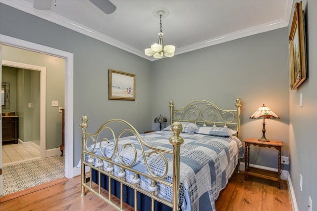 4512 Hardy Mcmanus Rd, Evans, GA 30809 - bedroom featuring baseboards, wood finished floors, crown molding, and ceiling fan with notable chandelier