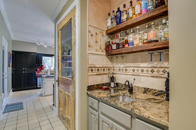4512 Hardy Mcmanus Rd, Evans, GA 30809 - bar featuring light tile patterned flooring, crown molding, wet bar, a sink, and backsplash