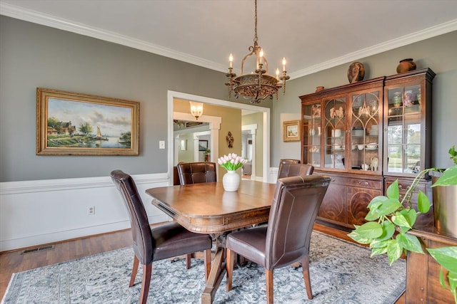 4512 Hardy Mcmanus Rd, Evans, GA 30809 - dining area featuring ornamental molding, visible vents, a notable chandelier, and wood finished floors