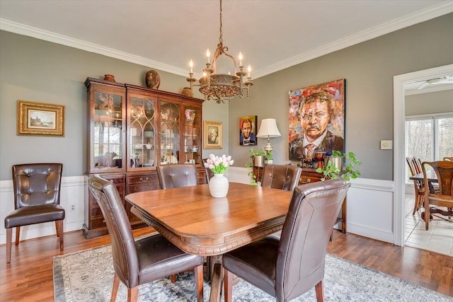 4512 Hardy Mcmanus Rd, Evans, GA 30809 - dining area featuring ornamental molding, light wood-style flooring, an inviting chandelier, and wainscoting