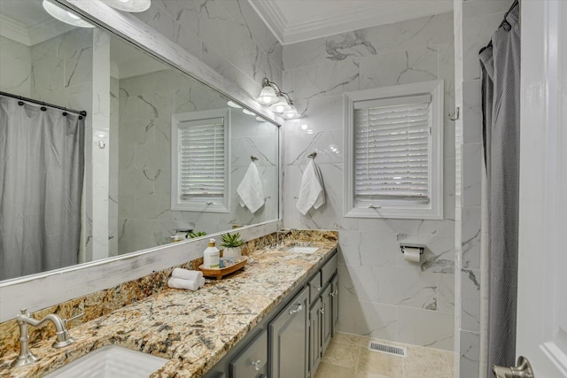 4512 Hardy Mcmanus Rd, Evans, GA 30809 - full bath featuring double vanity, a sink, ornamental molding, and tile walls