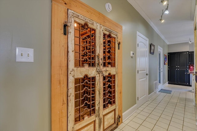 4512 Hardy Mcmanus Rd, Evans, GA 30809 - wine cellar featuring baseboards, crown molding, rail lighting, and light tile patterned floors