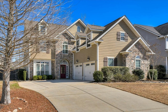 view of front of property with a garage, stone siding, and concrete driveway