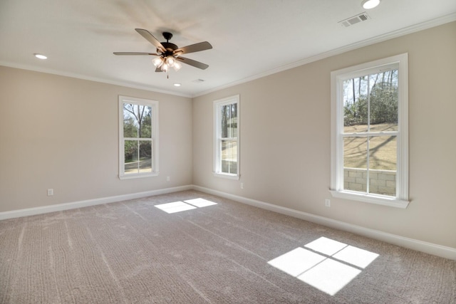 unfurnished room with visible vents, baseboards, and ornamental molding