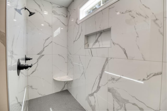 full bathroom featuring a marble finish shower