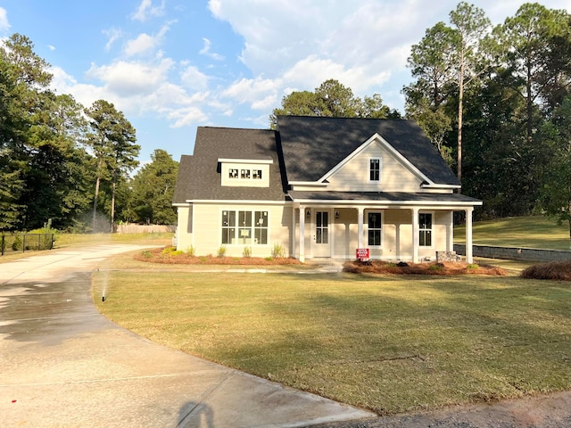 view of front of property with covered porch and a front lawn