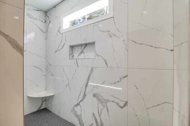 bathroom with a marble finish shower