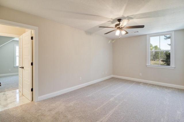 unfurnished room featuring carpet flooring, baseboards, and ceiling fan