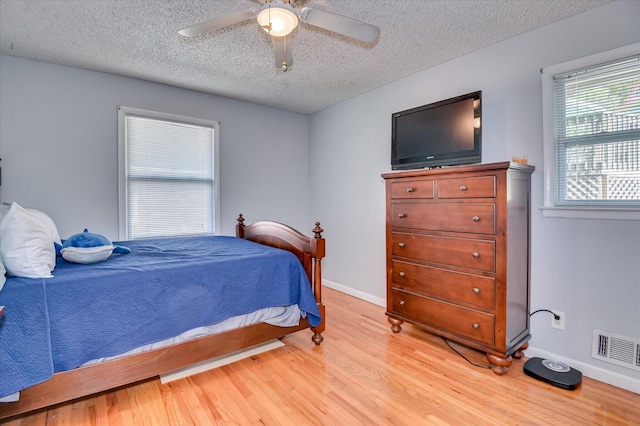 3114 Sussex Rd, Augusta, GA 30909 - bedroom with a textured ceiling, light wood-type flooring, and a ceiling fan