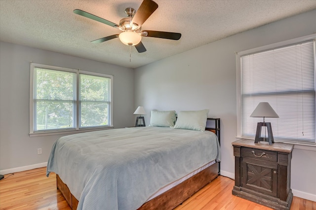 3114 Sussex Rd, Augusta, GA 30909 - bedroom with light wood-style floors, a textured ceiling, and a ceiling fan