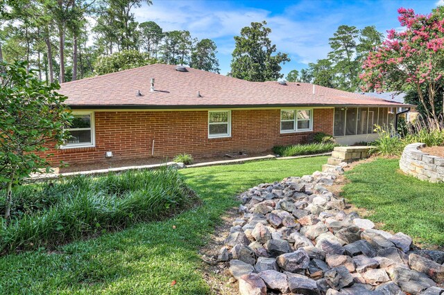 3114 Sussex Rd, Augusta, GA 30909 - view of front of house featuring a sunroom, brick siding, a front lawn, and a shingled roof