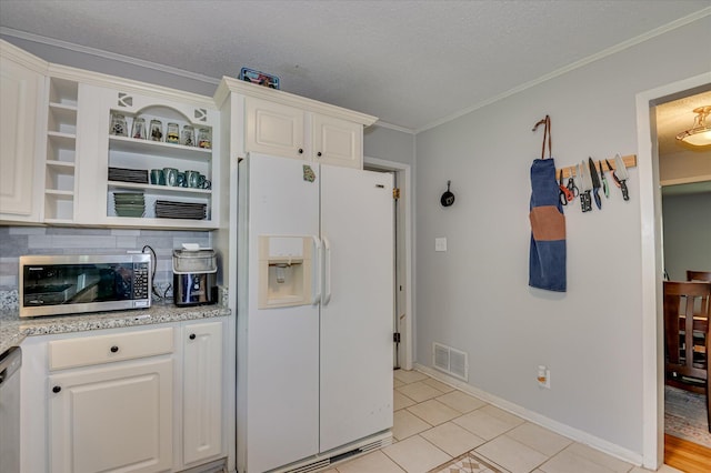 3114 Sussex Rd, Augusta, GA 30909 - kitchen featuring stainless steel appliances, white cabinets, tasteful backsplash, crown molding, and a textured ceiling