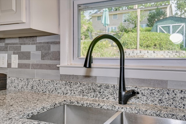 3114 Sussex Rd, Augusta, GA 30909 - kitchen view of tasteful backsplash, white cabinets, and light stone counters