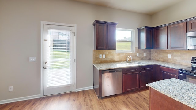 195 Sims Ct, Augusta, GA 30909 - kitchen with appliances with stainless steel finishes, light wood-style floors, tasteful backsplash, and light stone counters