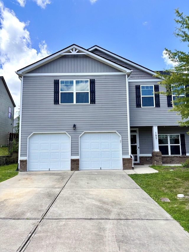 195 Sims Ct, Augusta, GA 30909 - view of front of house with concrete driveway, a garage, brick siding, and a front lawn