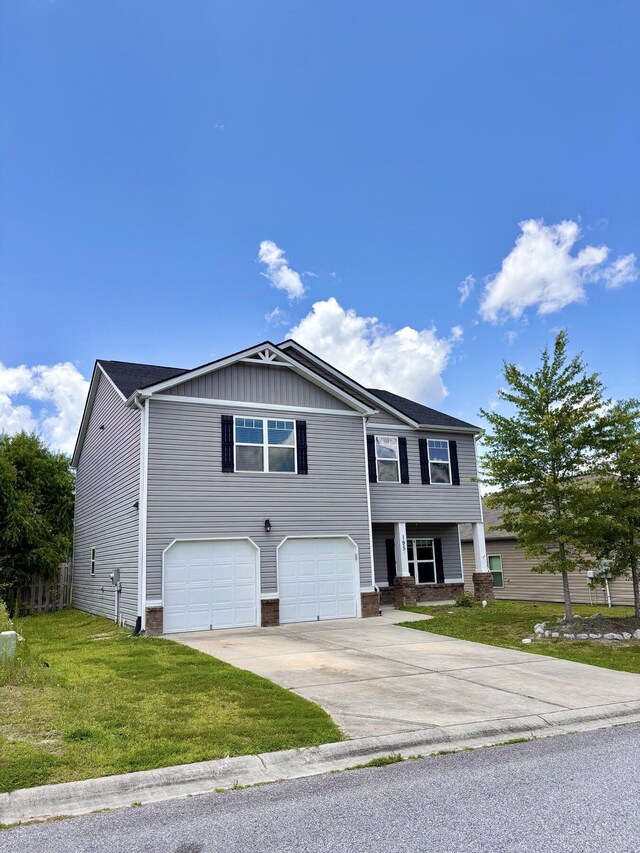 195 Sims Ct, Augusta, GA 30909 - view of front of house featuring an attached garage, driveway, a front lawn, and board and batten siding