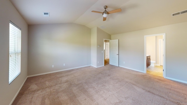 195 Sims Ct, Augusta, GA 30909 - unfurnished bedroom with vaulted ceiling, light carpet, connected bathroom, and ceiling fan