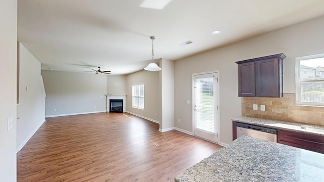 195 Sims Ct, Augusta, GA 30909 - kitchen featuring wood finished floors, a ceiling fan, stainless steel dishwasher, hanging light fixtures, and light stone counters