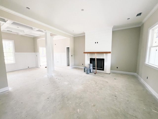 unfurnished living room featuring visible vents, ornamental molding, wainscoting, a fireplace, and unfinished concrete floors