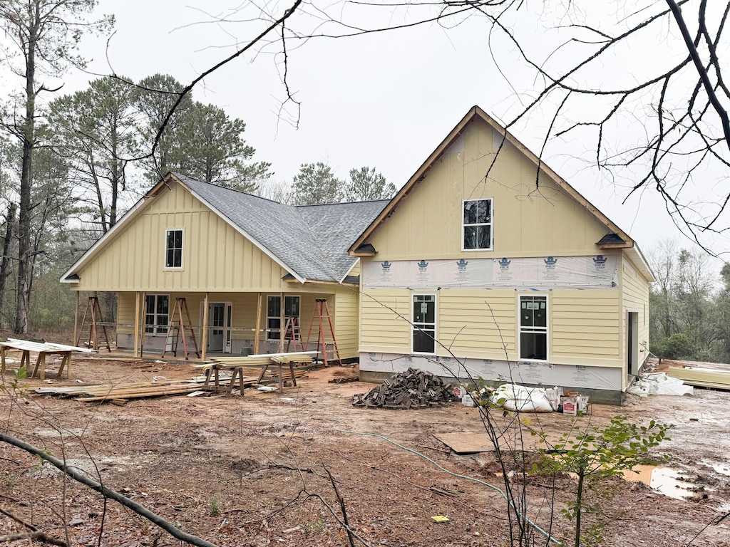 rear view of property with a porch