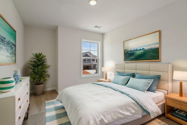 bedroom with visible vents and baseboards