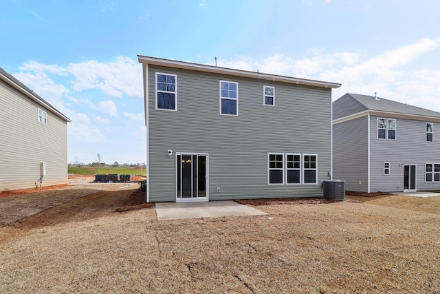 rear view of property featuring cooling unit and a patio area